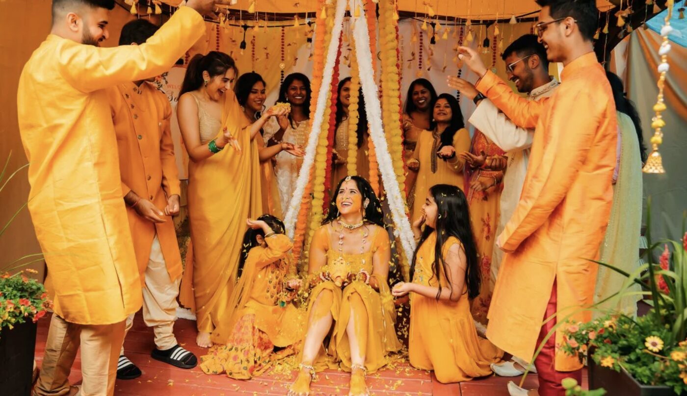 Wedding guests wearing different shades of yellow at a Haldi celebration
