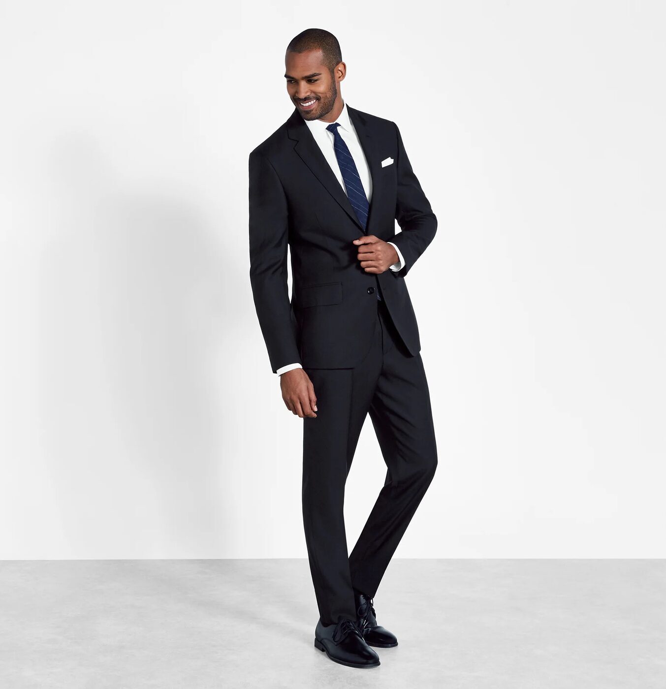 Black suit with a white shirt and black tie
