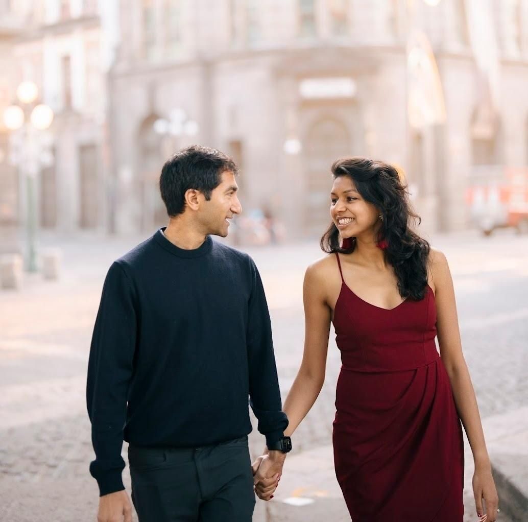 Rishi and Esha walking hand in hand on a cobblestone street in Puebla