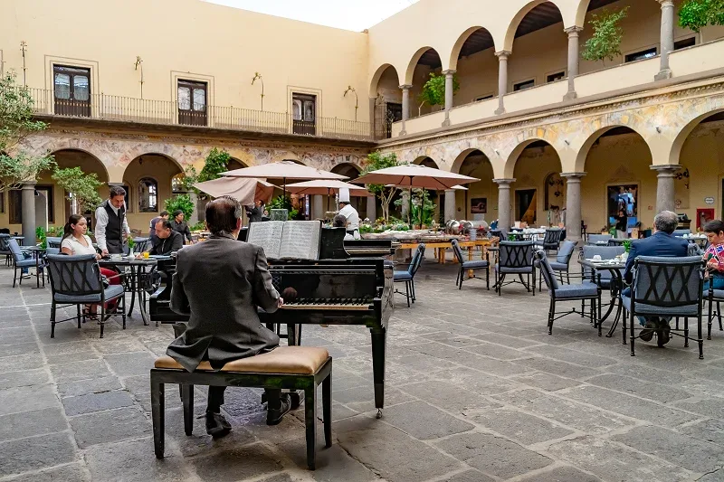 The colonial courtyard at Hotel Quinta Real Puebla, with stone archways